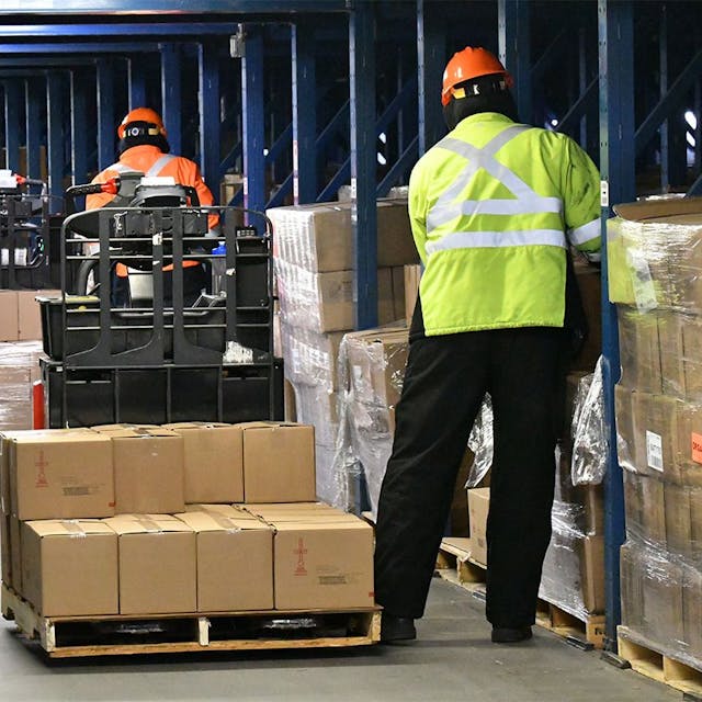 Two men picking products for pallet.